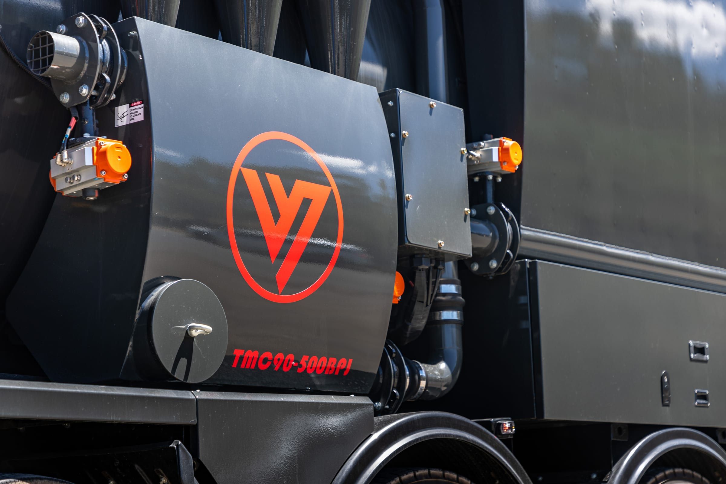 Close-up of the Vacvator logo on the side of the truck's black tank.